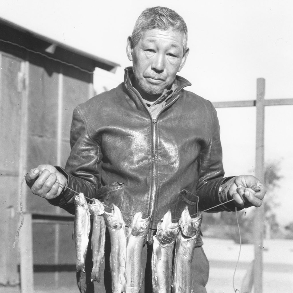 Heihachi Ishikawa with a stringer of golden trout in 1945, photo by Toyo Miyatake