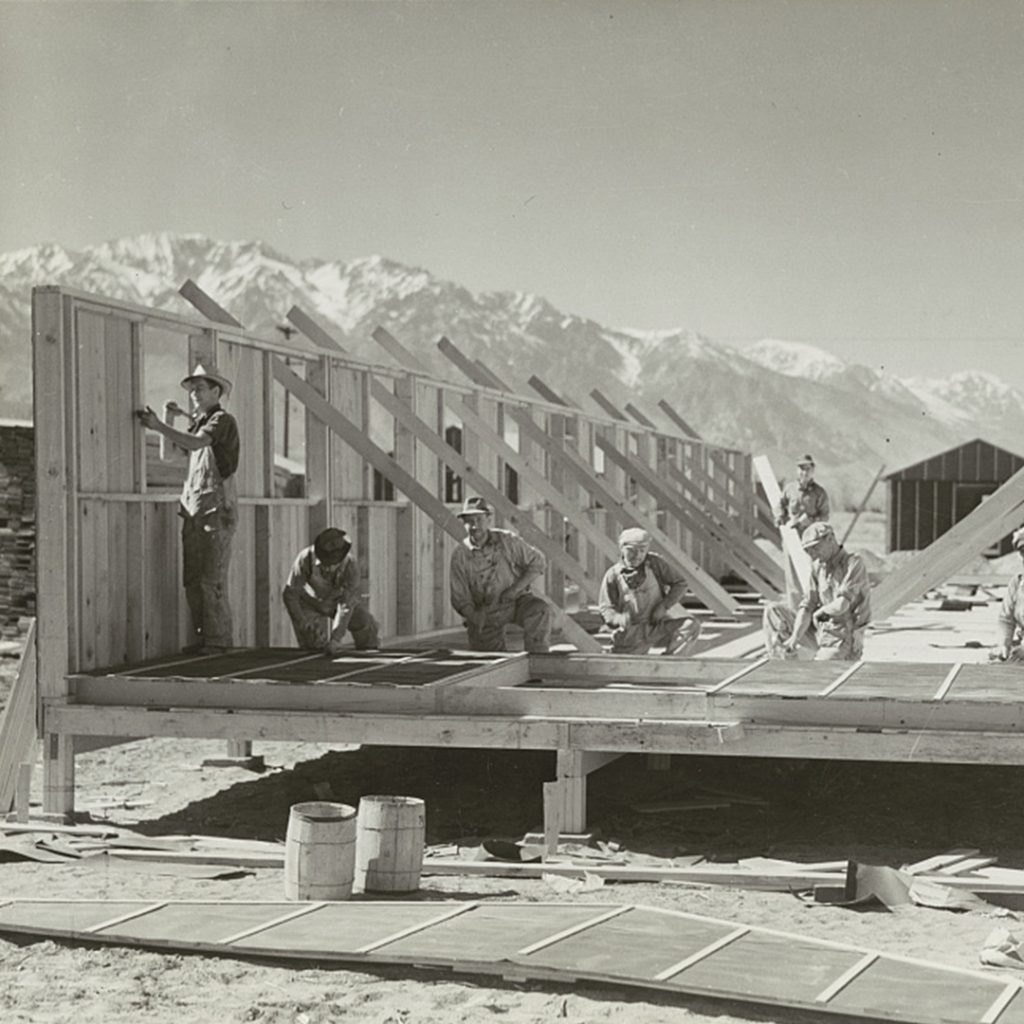 Carpenters constructing quarters for Japanese American evacuees at Manzanar, credit NARA