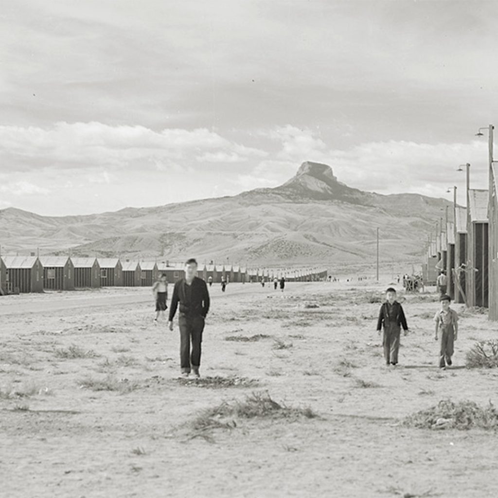 Looking west of F Street with Heart Mountain looming in the background, 1942. Photo by Tom Parker, credit The Bankroft Library, University of California, Berkeley