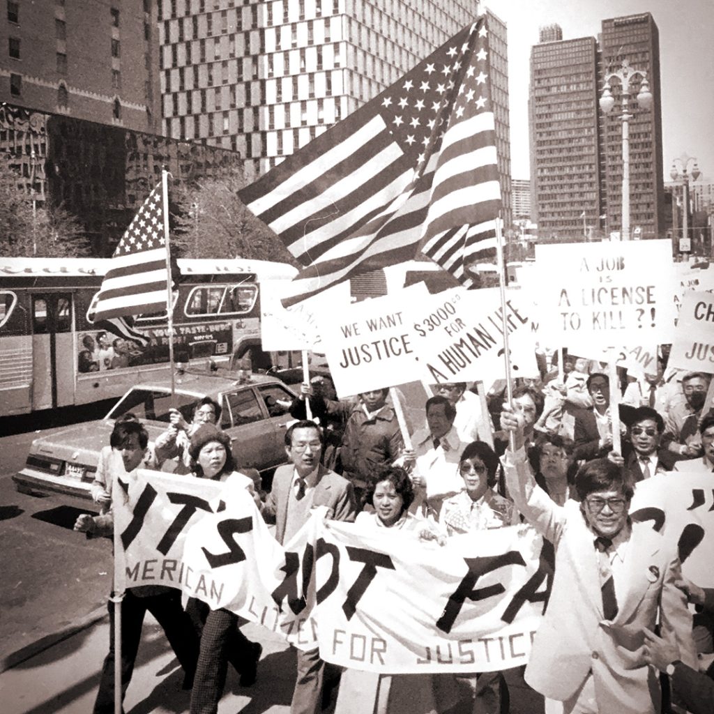 People marching by Detroit’s Renaissance Center in protest of the sentence of Chin’s killers being too light, May 9, 1983, credit Associated Press