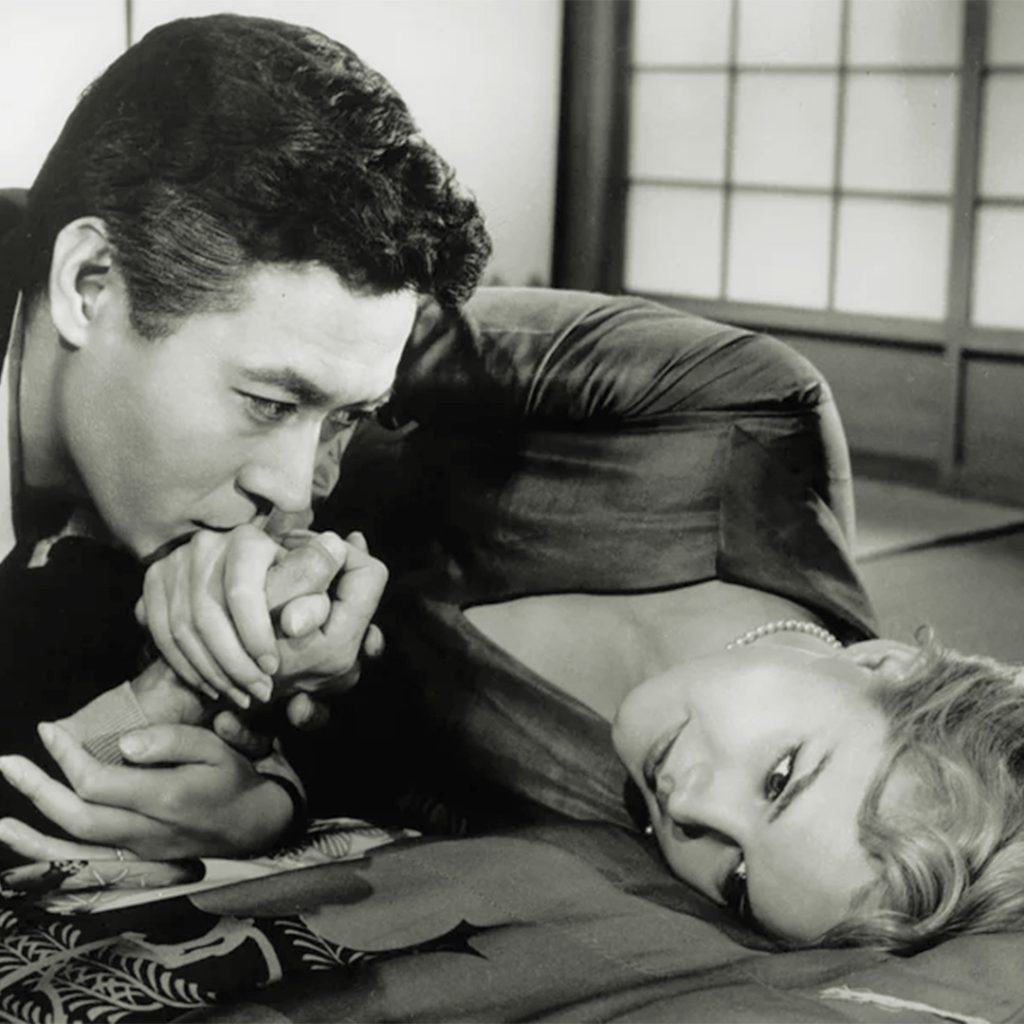 Based on a true story about the difficulties of a young woman married to a Japanese diplomat during WWII. James Shigeta with Carrol Baker in “Bridge to the Sun,” 1961