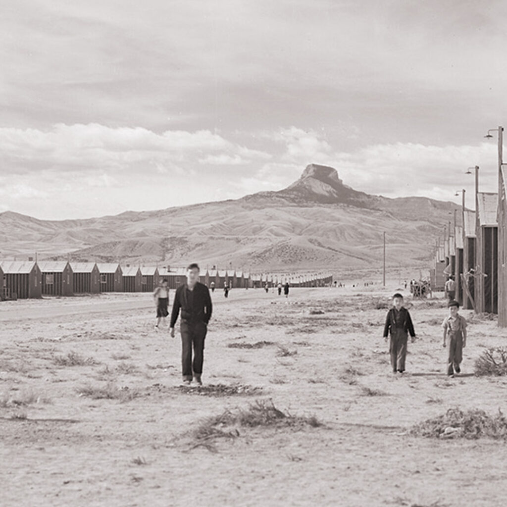 Looking west of F Street with Heart Mountain looming in the background, 1942. Photo by Tom Parker, credit The Bankroft Library, University of California, Berkeley