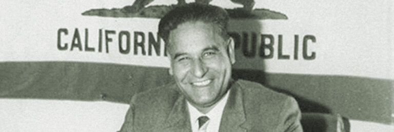 Dalip Singh Saund in front of the California flag