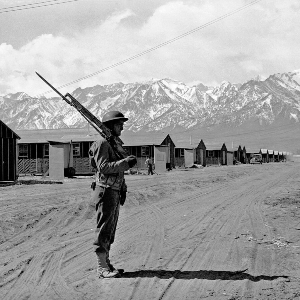 An American soldier guarding the incarceration camp at Manzanar, May 23, 1943, AP Photo