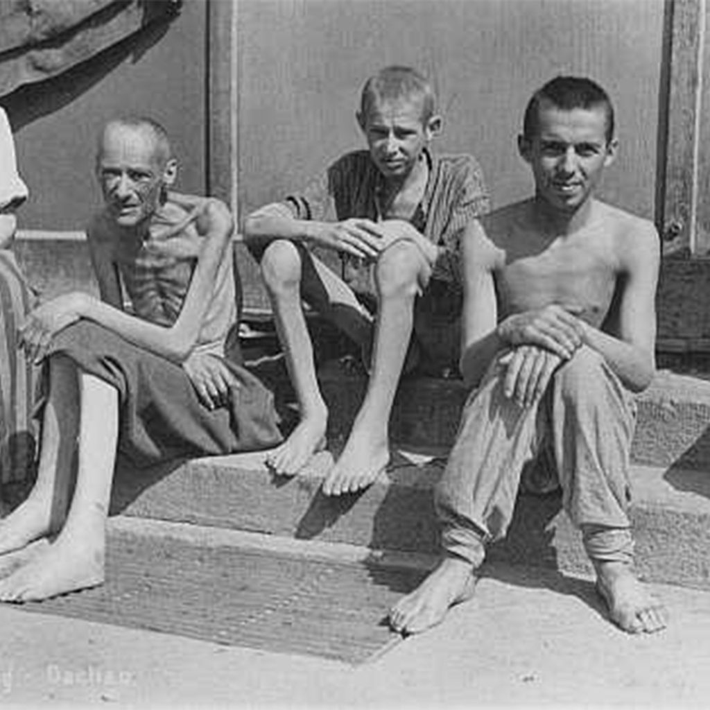 Emaciated survivors soon after liberation, Dachau, Germany, credit Ministere de la Defense