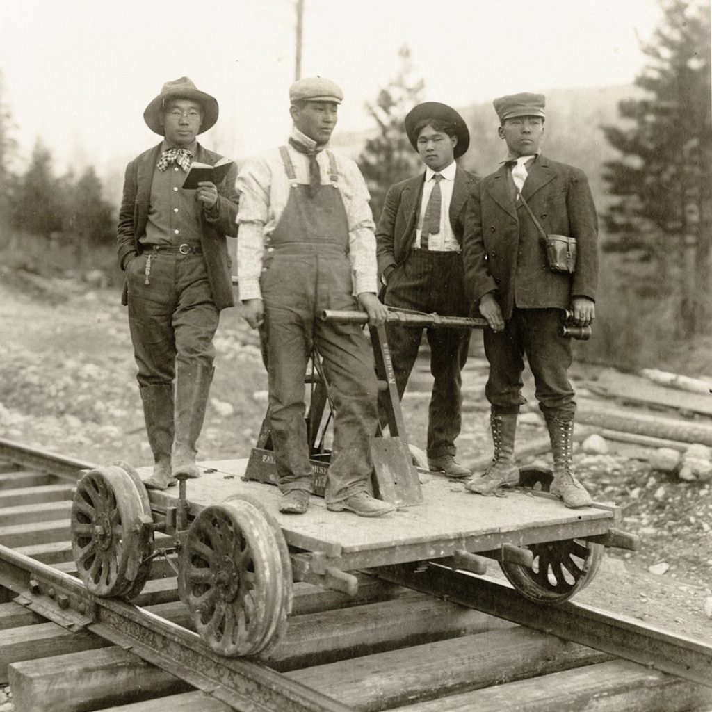 Four Japanese American men on a handcar, c1905, near Butte, Montana