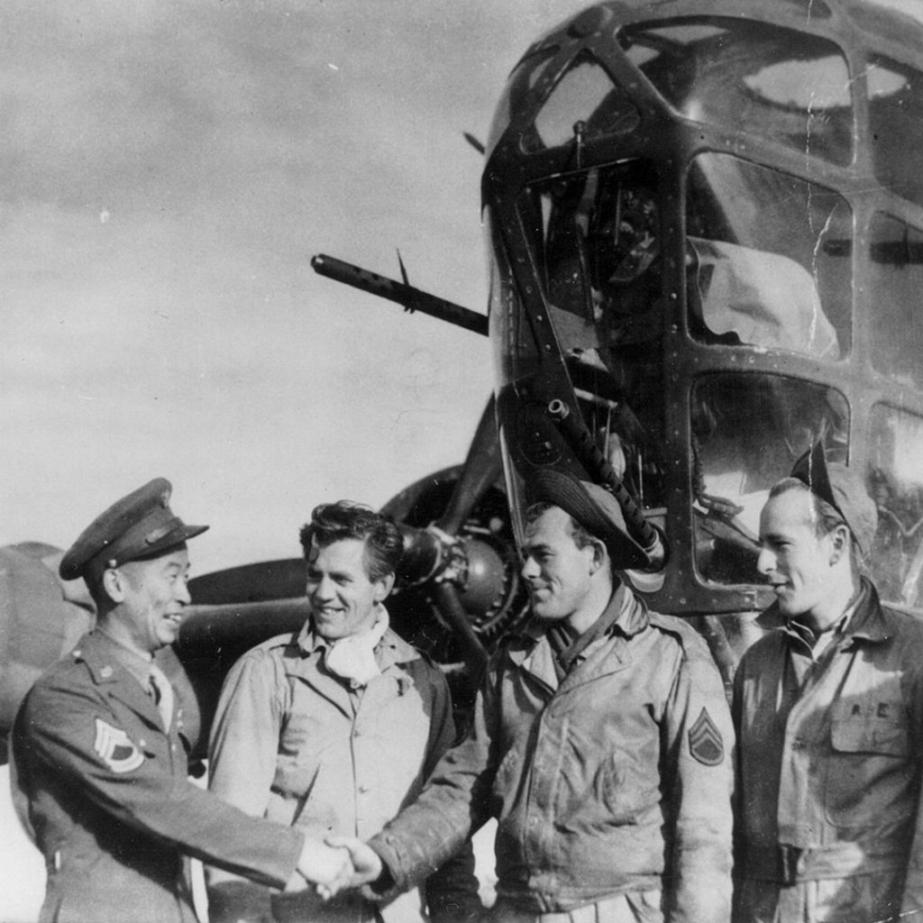 Ben Kuroki shaking hands with "Tupelo Lass" ground crew member prior to the Ploesti, Rumania raid, August 1, 1943