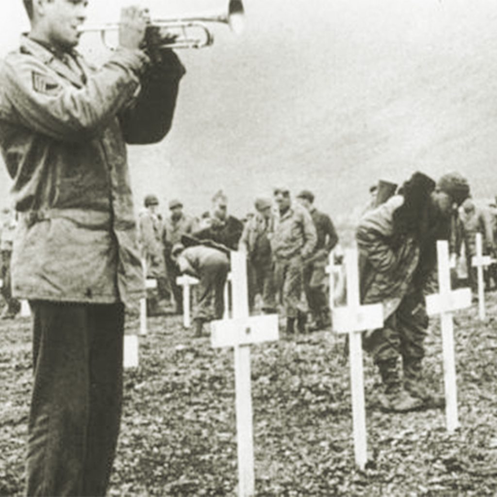 A bugler sounds taps during a memorial service, Attu Island, Alaska, August 1943, credit AP Photo