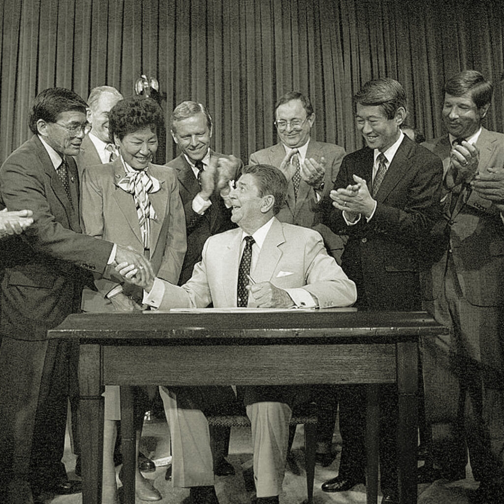 President Ronald Reagan signing the Civil Liberties Act of 1988. Courtesy of Ronald Reagan Presidential Library and Museum/NARA