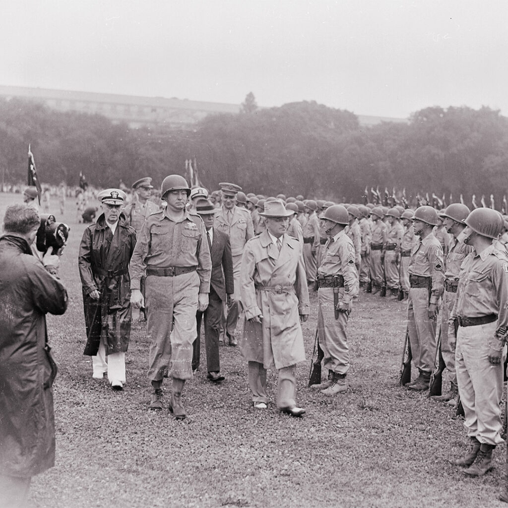 President Truman walking past troops standing attention during his review of the Japanese-American 442nd Regimental Combat Team, Washington DC, July 15, 1946