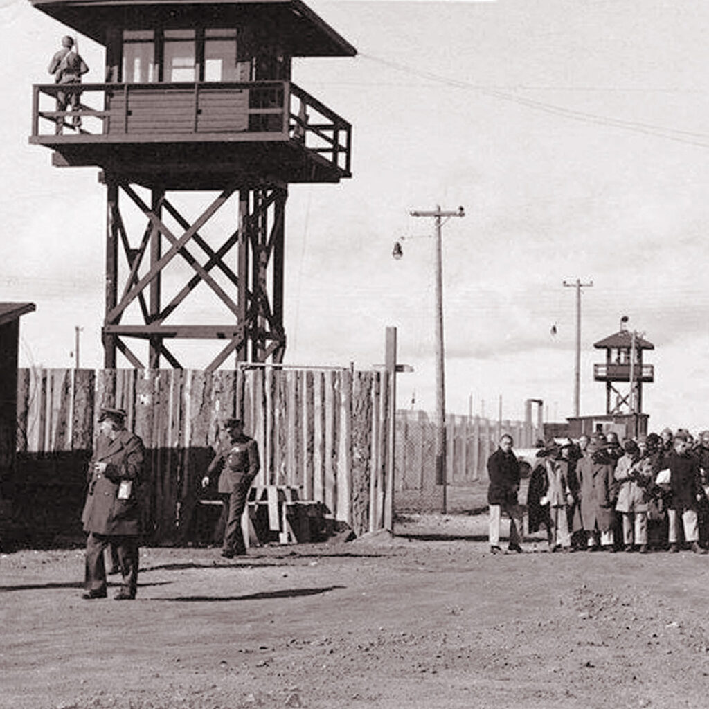 Tule Lake Segregation Center was surrounded by barbed wire fencing and guarded from towers by soldiers with guns