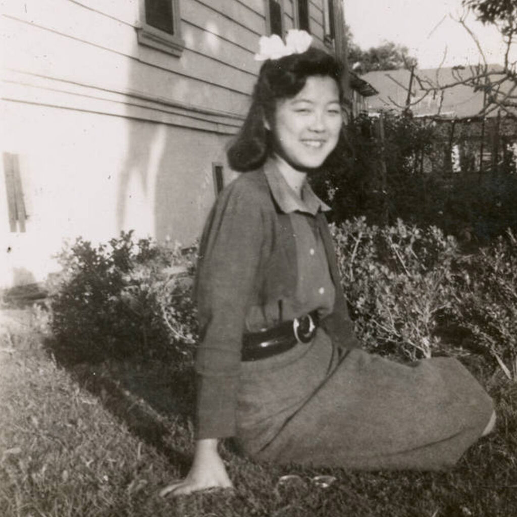 Aiko Herzig-Yoshinaga sitting on the grass, 1937, credit John Yoshinaga and California State University Japanese American Digitization Project