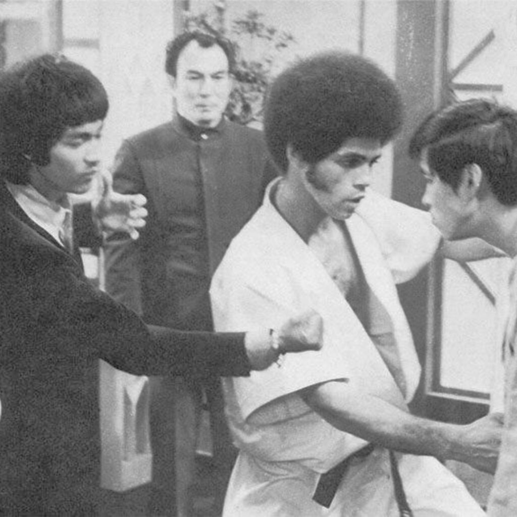 Bruce Lee choreographing a fight scene with Jim Kelly on the set of Enter the Dragon.