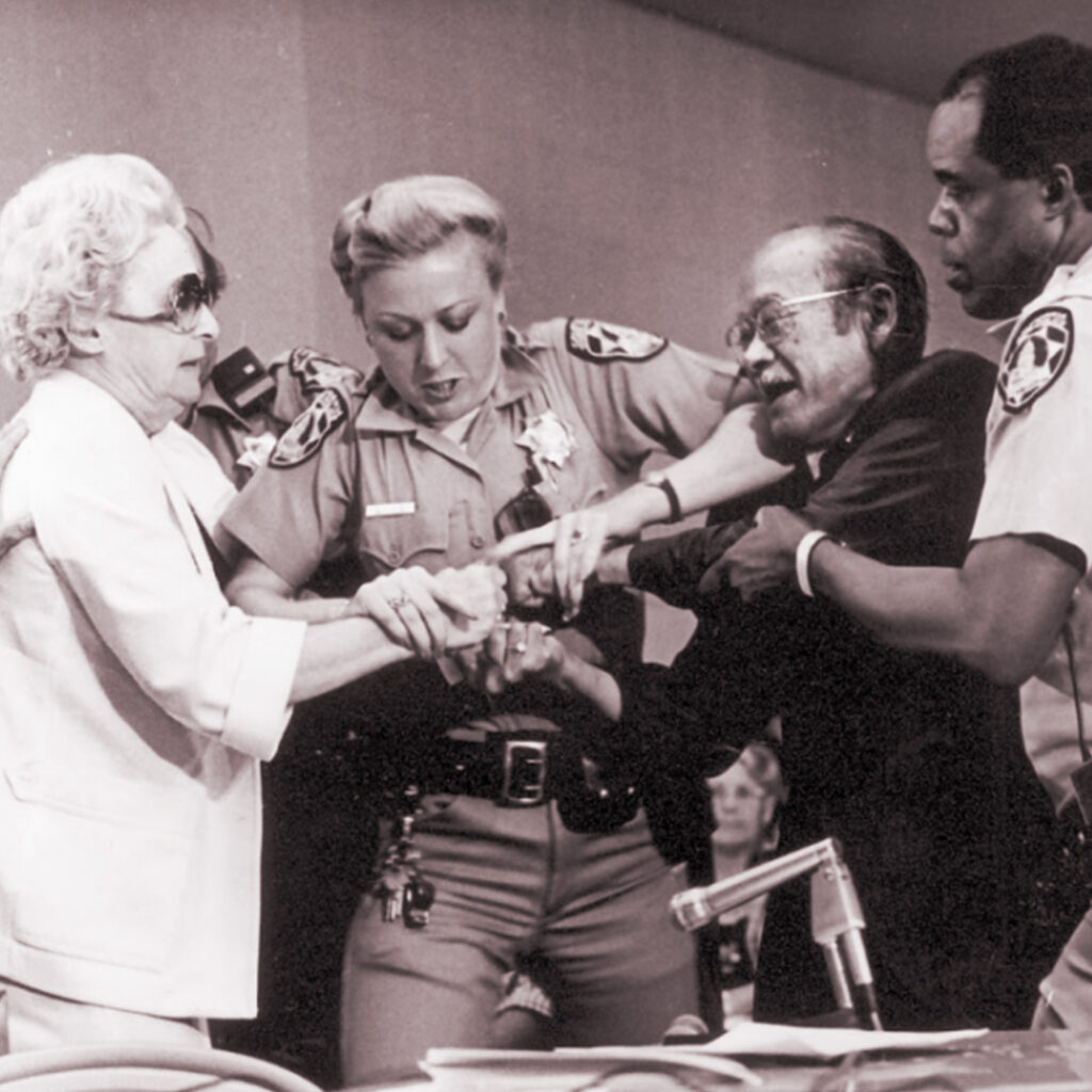 Lillian Baker trying to snatch Jim Kawaminami's papers, Los Angeles, 1981, credit Densho Encyclopedia