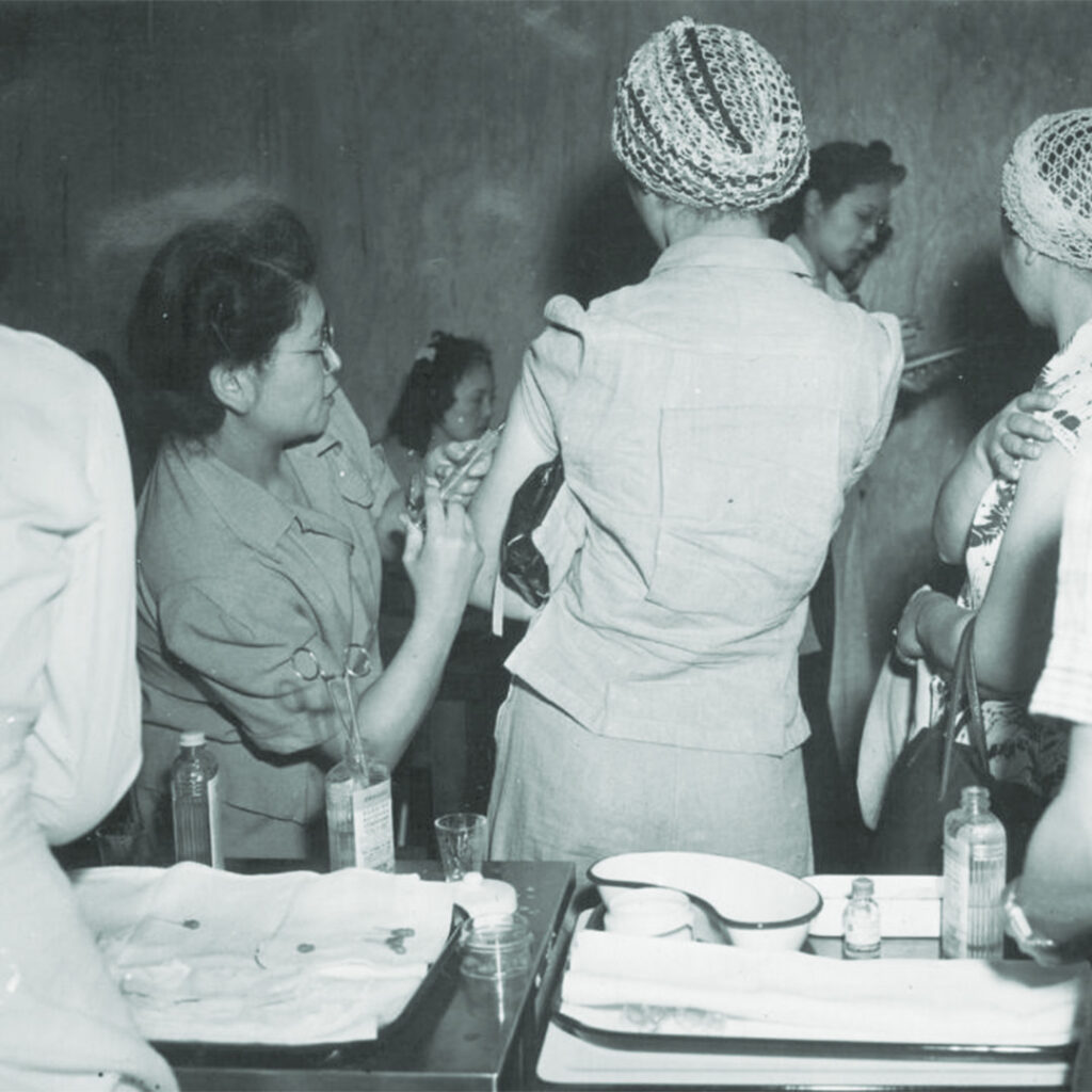 Dr. Kazue Togasaki, the eldest of six sisters, administering vaccines while incarcerated during WWII.