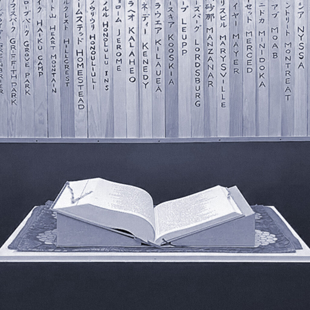 The Ireichō on display at the Japanese American National Museum, backed by wooden sotoba naming each site of wartime incarceration. Photo by Doug Mukai