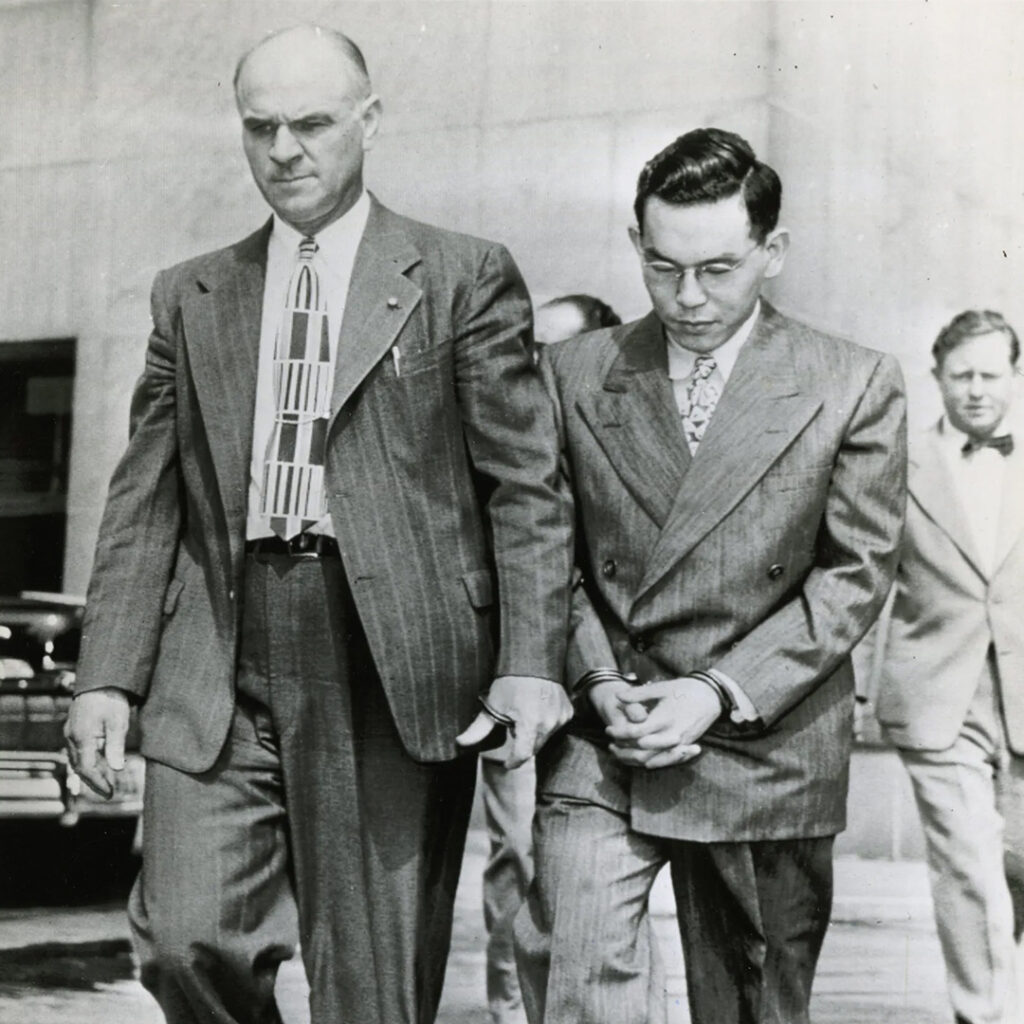 Tomoya Kawakita arrives in handcuffs for the start of his treason trial in Los Angeles, June 18, 1948.