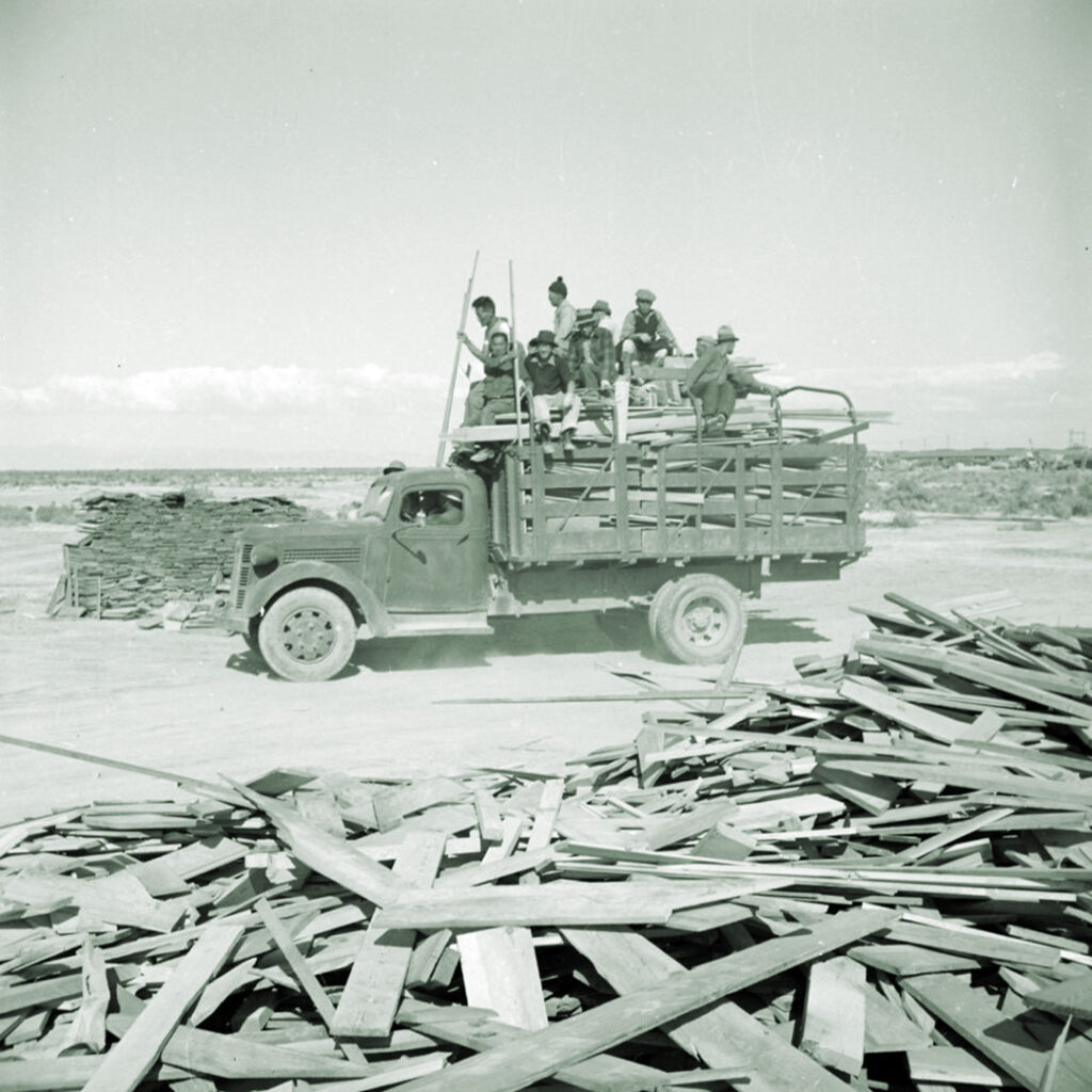 Volunteer workers at Topaz gathering scrap wood from construction sites.