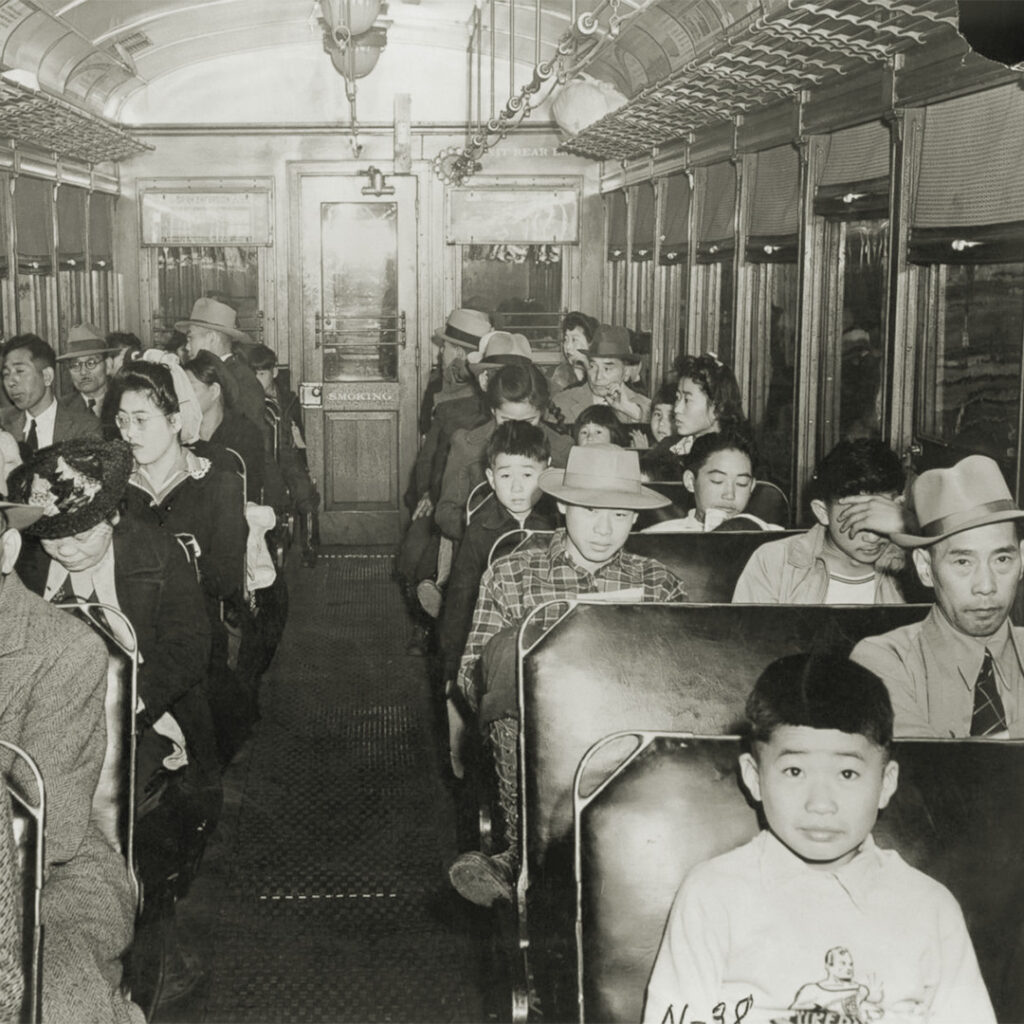 Incarcerees riding a train to the incarceration camp