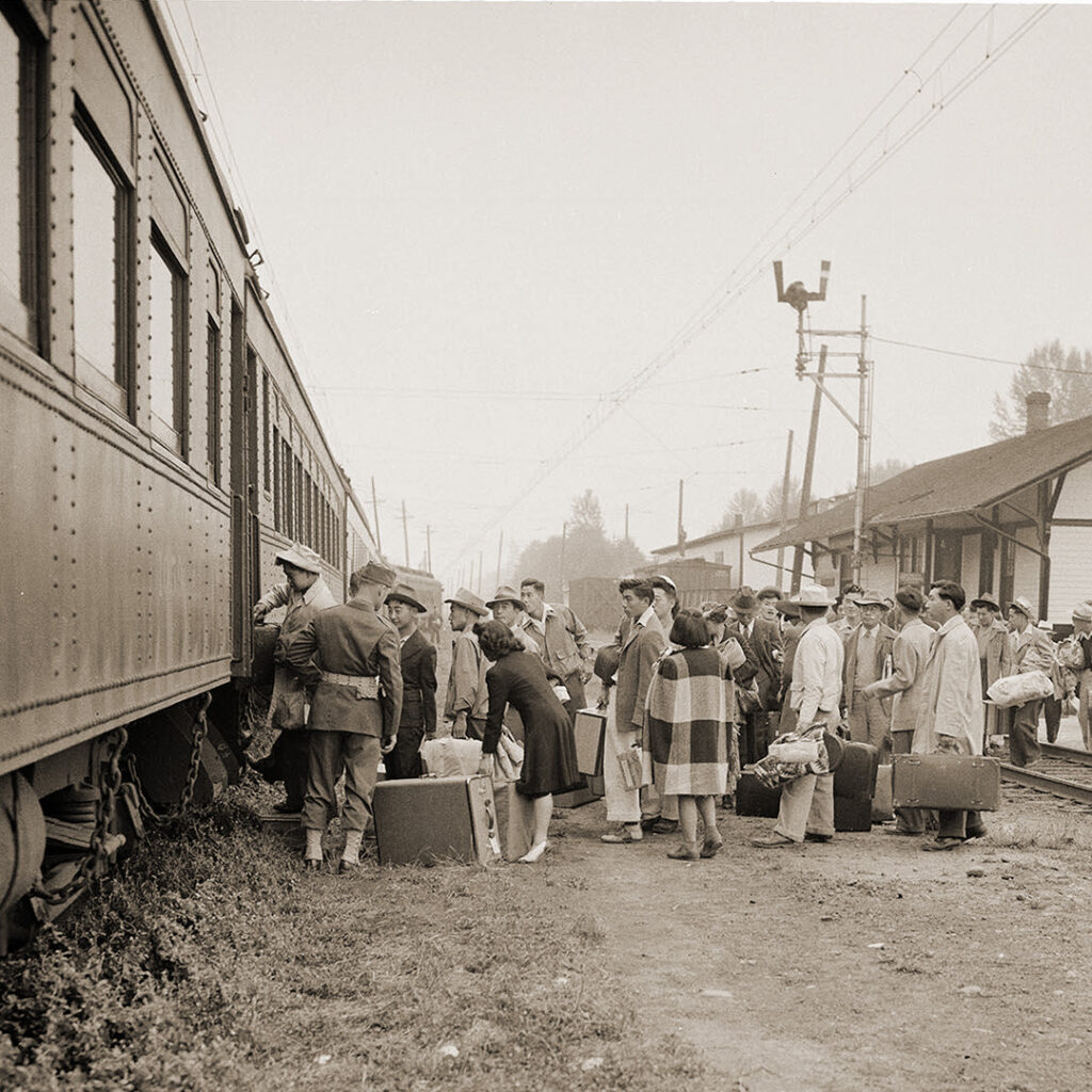 Japanese Americans forced onto a train bound for Minidoka, Idaho. Puyallup, Washington, 1942.