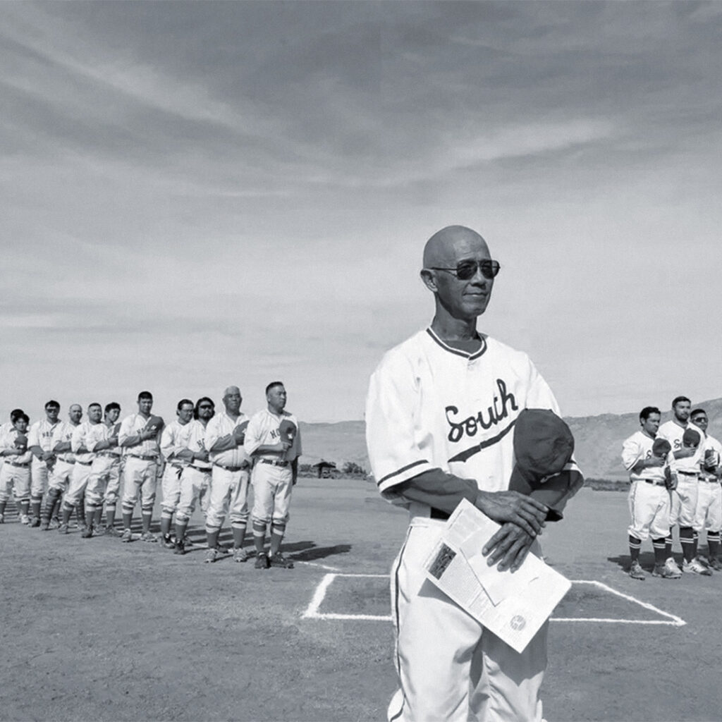 Dan Kwong standing with players from the North and South All-Stars during the 2024 commemorative game at Manzanar.
