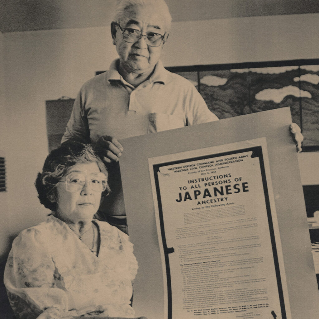 Mary and Al Tsukamoto holding a copy of the Executive Order 9066. AP Photo 1986.