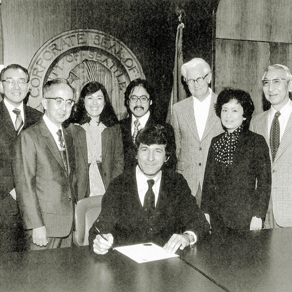 Seattle Mayor Charles Royer signing the nation’s first Day of Remembrance proclamation, November 1978. Courtesy of Densho, Kinoshita Family Collection (ddr-densho-10-15)