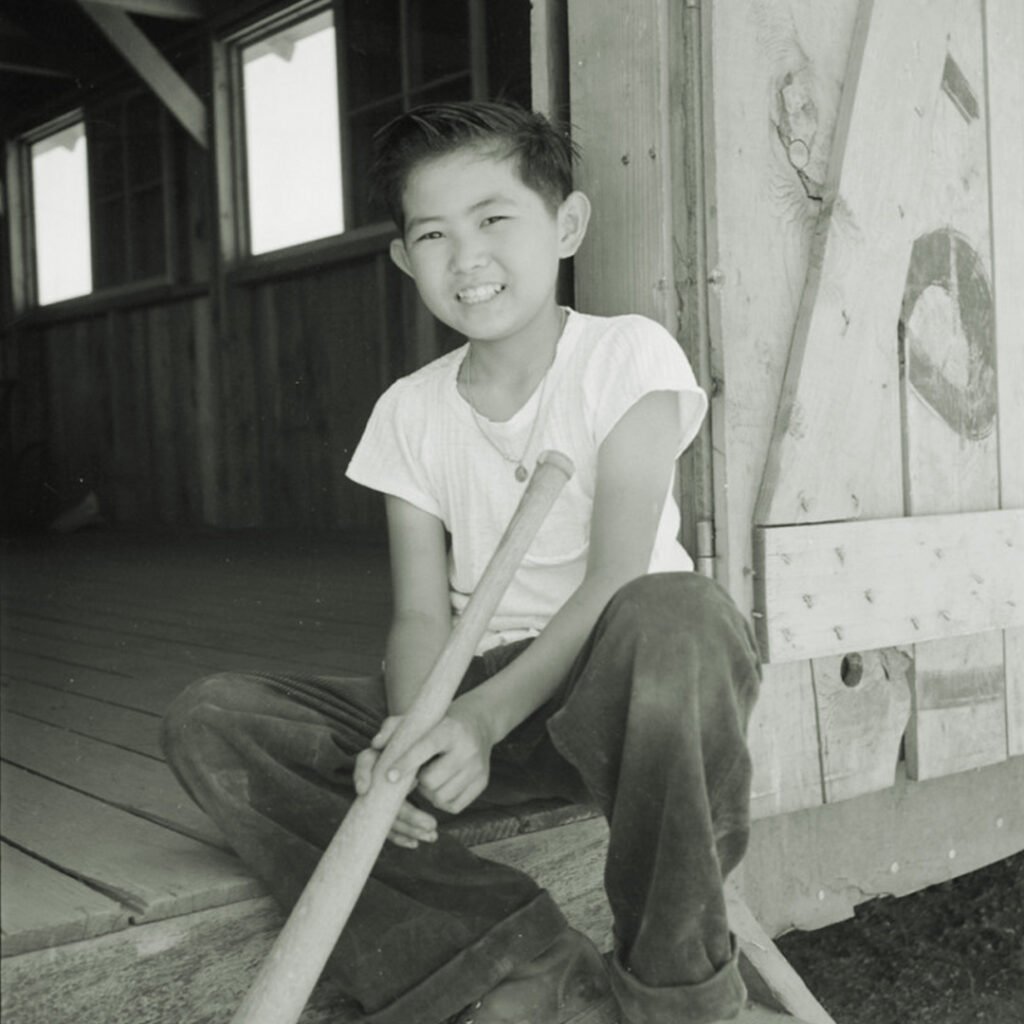Boy with a bat at Manzanar. Photo by Dorothea Lange.