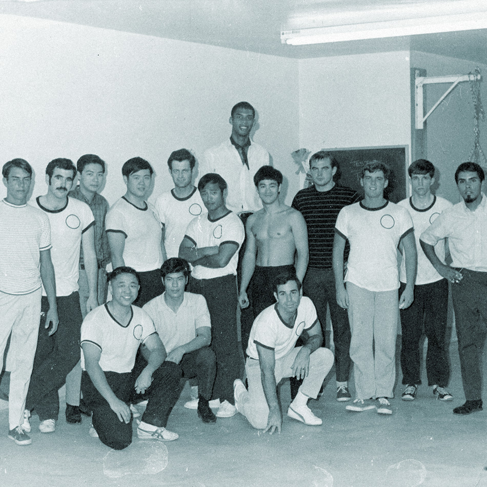 Bruce Lee surrounded by students in his LA Chinatown School