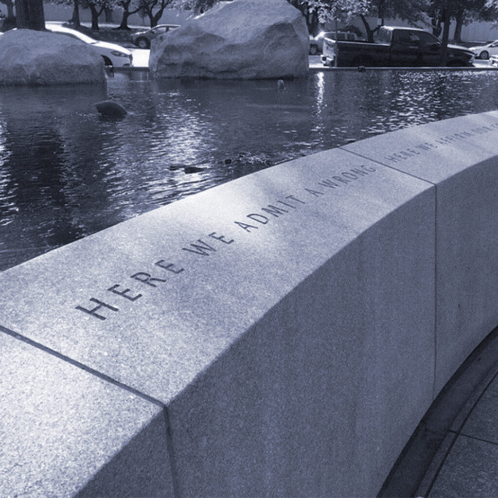 The words “Here we admit a wrong” from President Ronald Reagan’s 1988 Civil Liberties Act address, engraved at the National Japanese American Memorial to Patriotism During World War II.