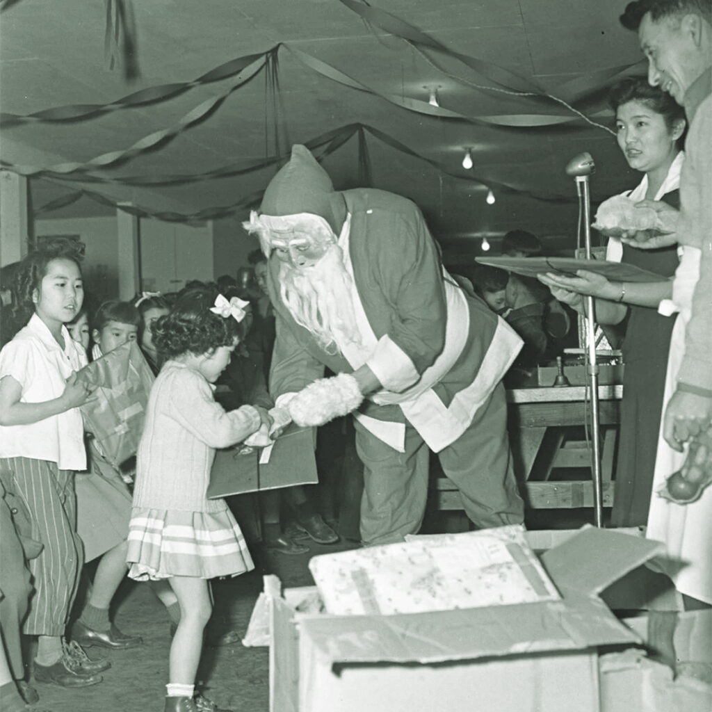 Santa handing out gifts to children, Heart Mountain, 1943.