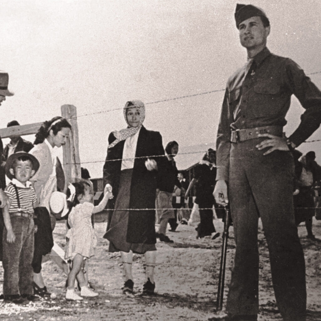 Guard with Japanese Americans visiting family at Heart Mountain