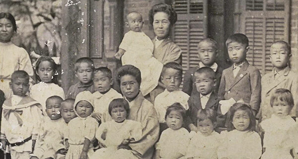Yeiko Mizobe So (seated with a child on her lap) at the Home for Neglected Children, 1912, courtesy of Nu'uanu Congregational Church archives