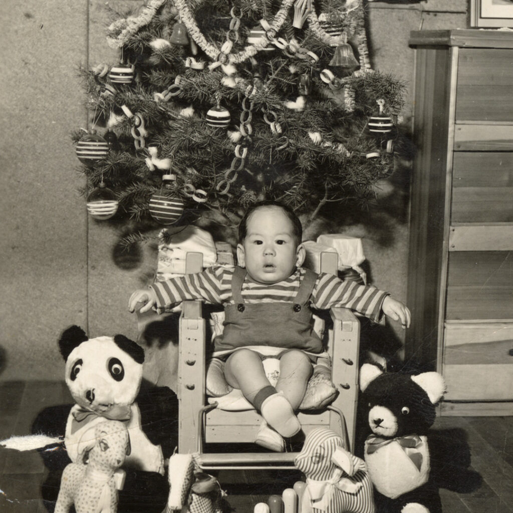 A baby girl inside a barrack during Christmas season, Heart Mountain, 1944.