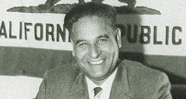 Dalip Singh Saund in front of the California flag
