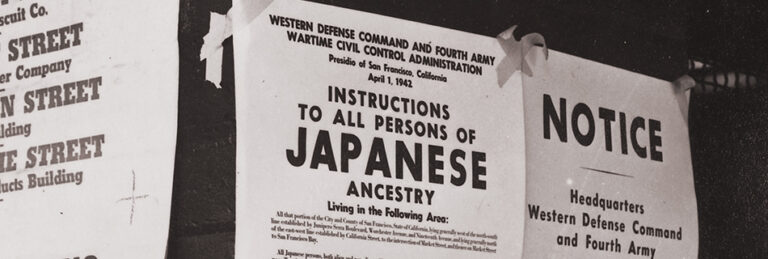 San Francisco, California. On a brick wall beside air raid shelter poster, exclusion orders are posted. Photo by Dorothea Lange. NARA - 536018
