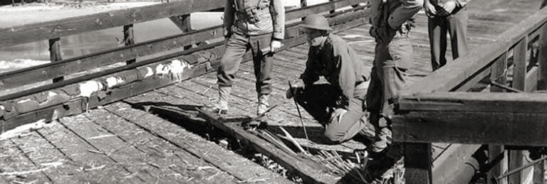 soldiers inspecting the splintered decking at Ellwood oil pier