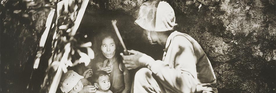 A member of a Marine patrol on Saipan found this family of Japanese civilians hiding in a hillside cave. June 21, 1944 - NARA - 532380